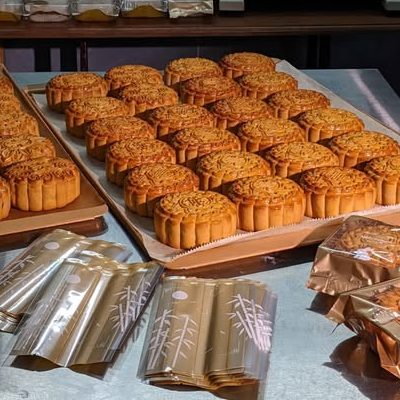 Khay bánh nướng Trung thu vừa ra lò trong bếp, bên cạnh những túi đóng gói ánh vàng